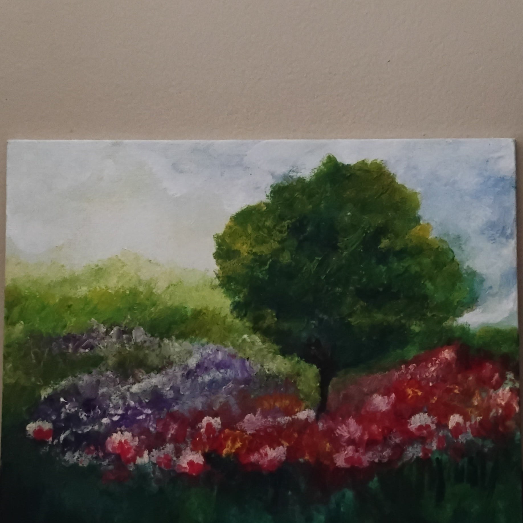Oil painting of tree with flowers and a blue sky